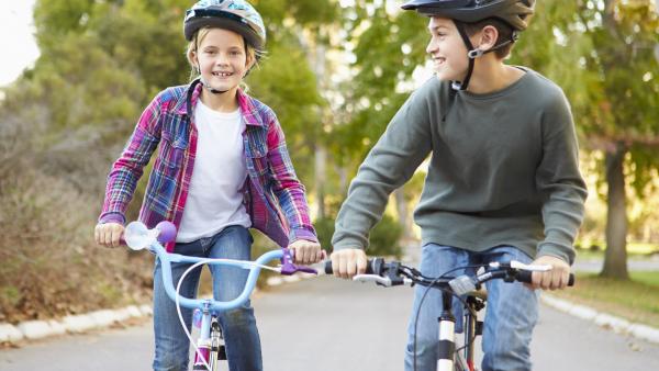 Two Children On Cycle Ride In Countryside